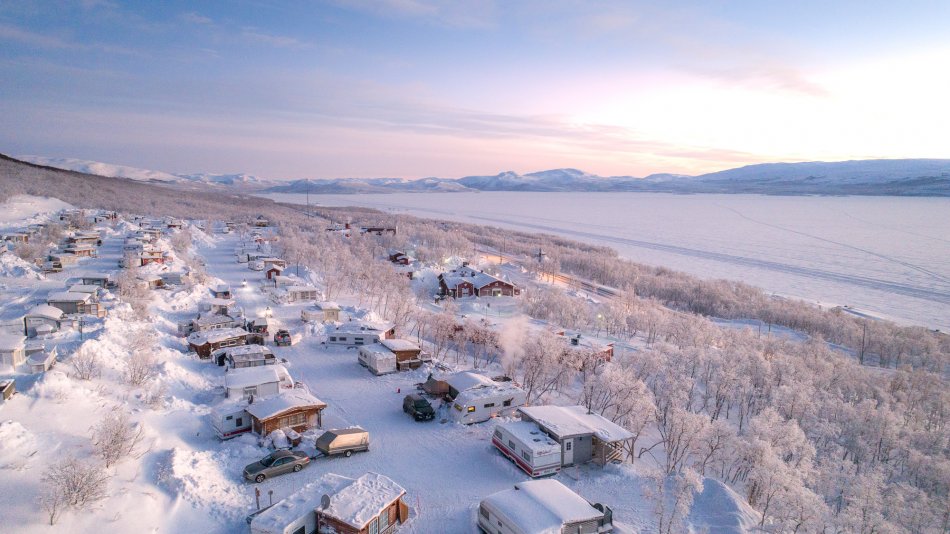 Camping site in Kilpisjärvi pictured from slightly above on a pastel coloured and cold winter day.